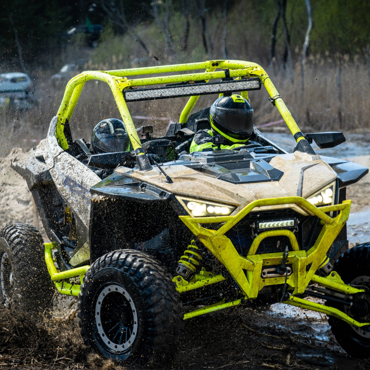 ATV and UTV offroad vehicle racing in hard track with mud splash.