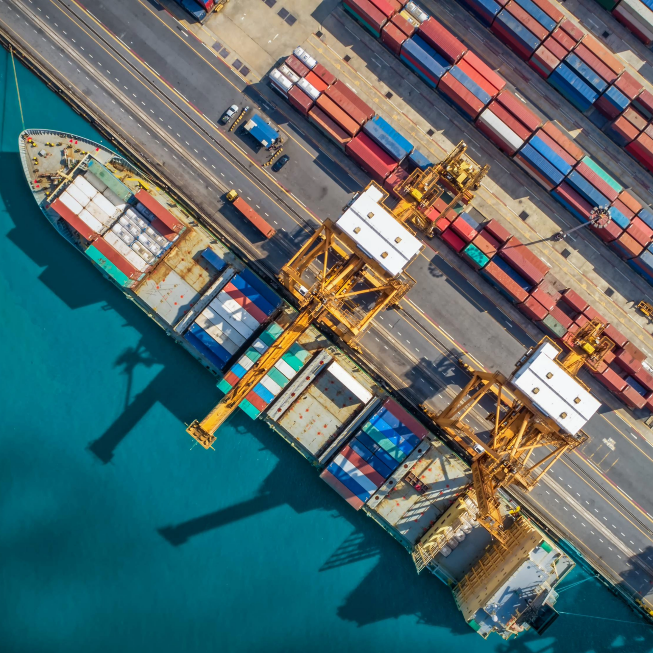 Aerial view of cargo ships docked at a busy port